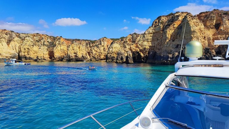 Golden cliffs and turquoise water at Ponta da Piedade seen from a private yacht